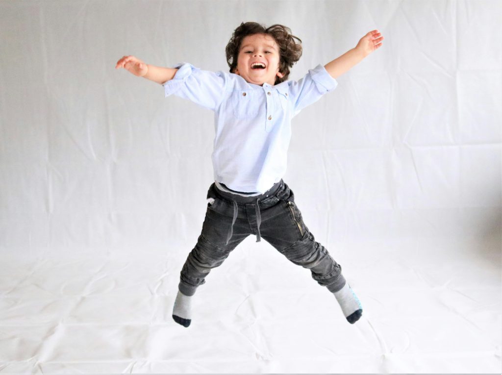Boy child jumping in mid air
