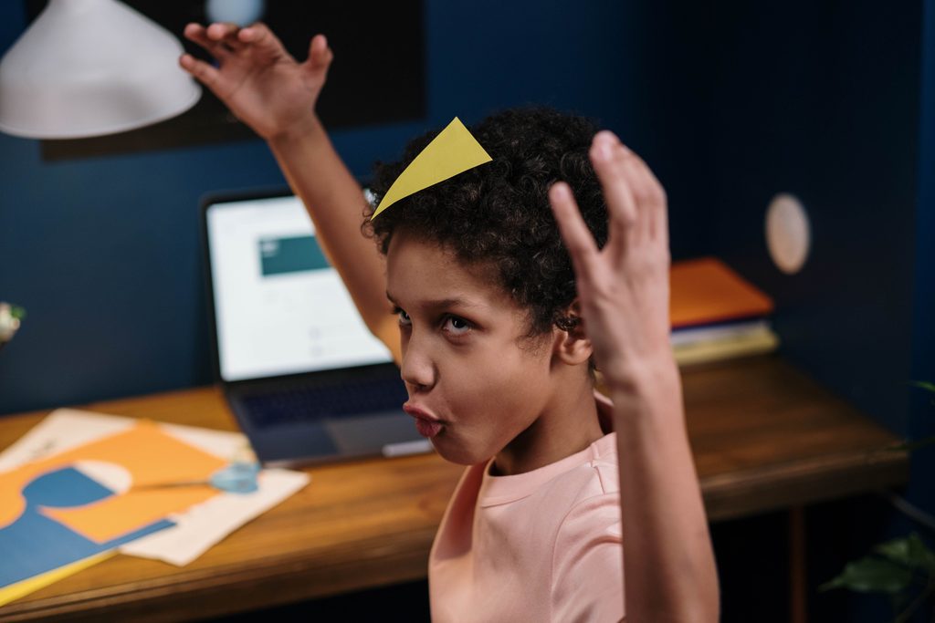 Child making funny faces instead of doing homewokr