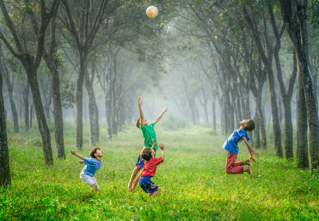 Children in colour clothes playing outdoors